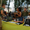 Creative writing students occupy a poetry table during an outdoors event on campus.