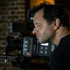 A close up of a man filming.