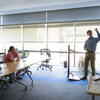 A professor in a classroom speaking to students sitting at desks
