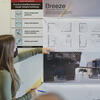 A masked student presents her architectural designs.