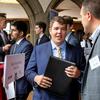 A Fox student converses with representatives of a local company.