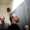  Student figuring out equations with the assistance of dedicated Temple faculty members.